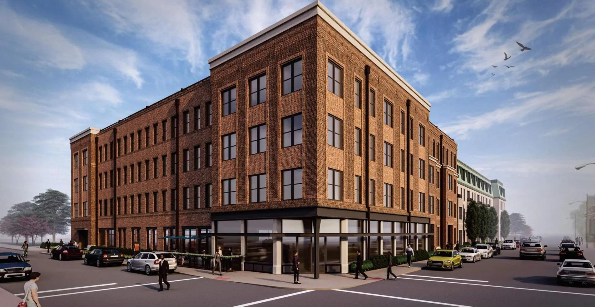 A new brick building situated on a corner lot, showcasing multiple windows and a modern design.