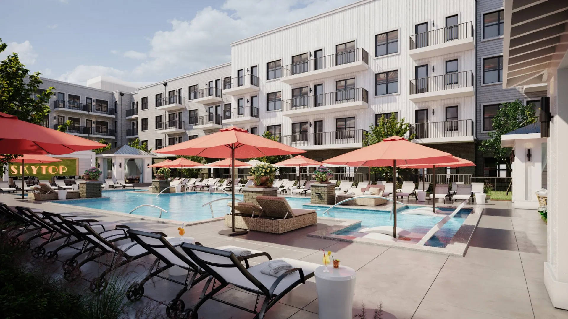 A luxurious pool area with lounge chairs and red umbrellas, surrounded by a modern apartment building.