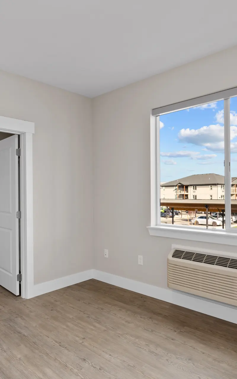 Primary bedroom in an unfurnished apartment, showcasing clean, spacious design