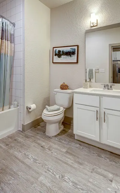 Modern apartment bathroom at 120 Ninth Street with a single vanity, shower, and stylish fixtures.
