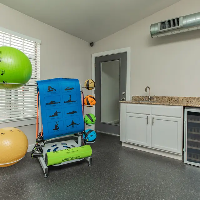 Artisan at South Lamar Fitness recovery space at Artisan at South Lamar featuring yoga mats, stability balls, and a hydration station in Austin, TX