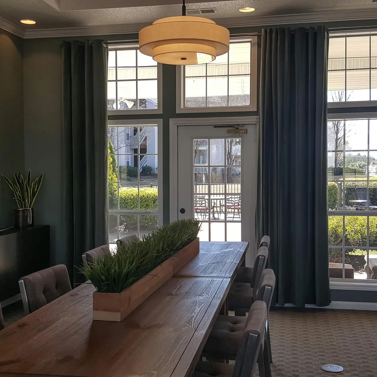 commons area table with a door out to large porch and swimming pool