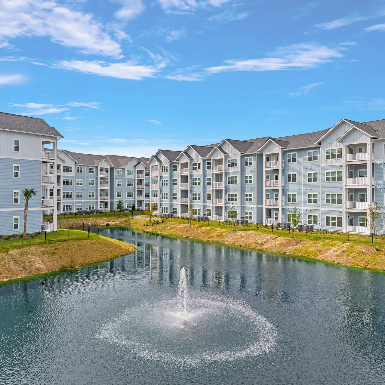 aerial view of buildings overlooking pond