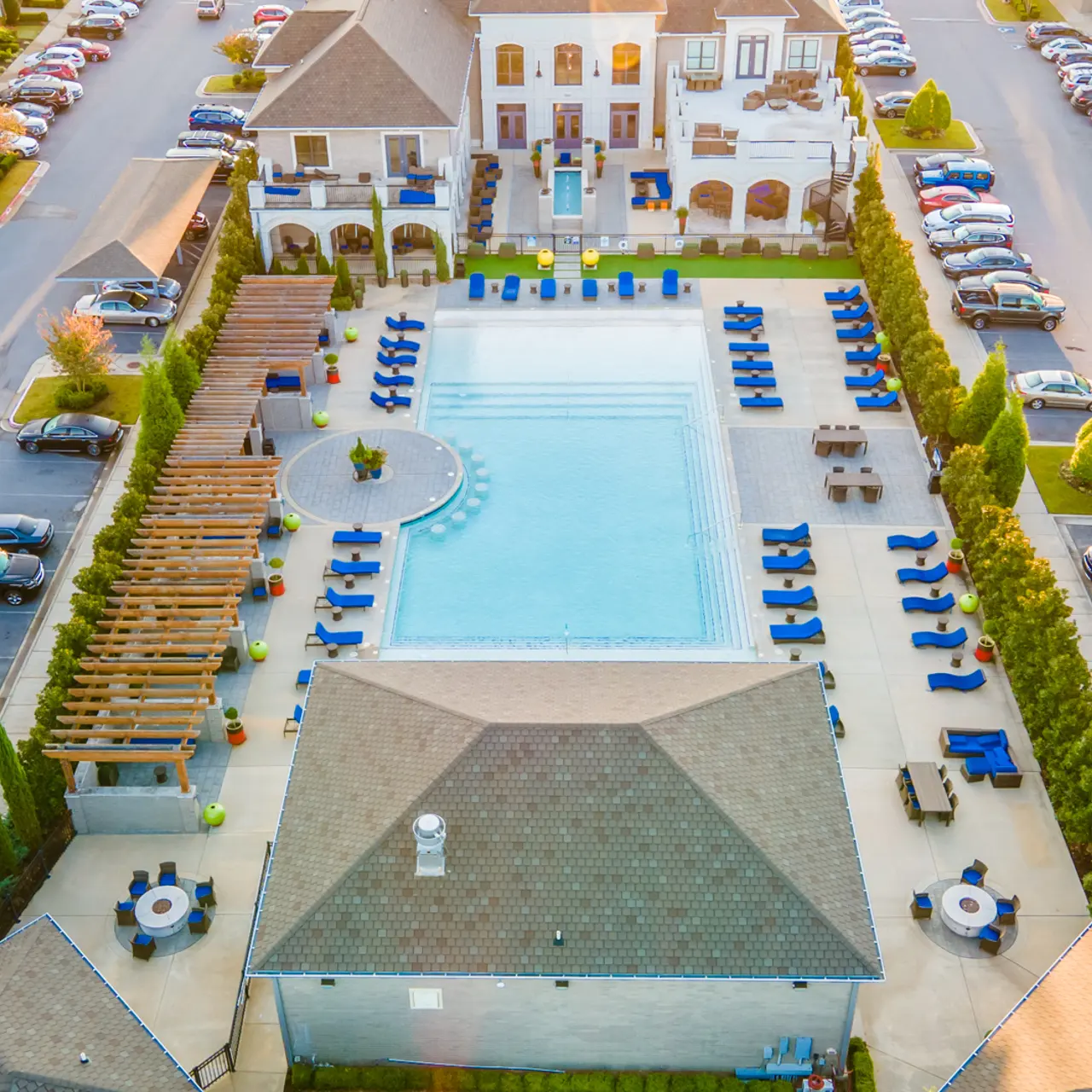Aerial photo of the pool at The Pointe Brodie Creek in Little Rock, Arkansas. The full pool is in view, including the poolside fire pits and cabanas.