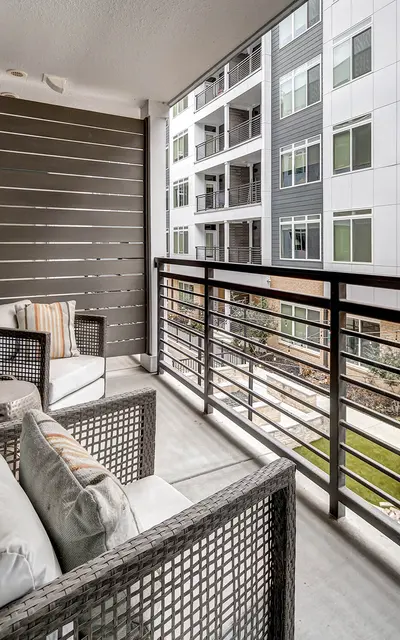 Apartment balcony overlooking a courtyard and neighboring building at 120 Ninth Street
