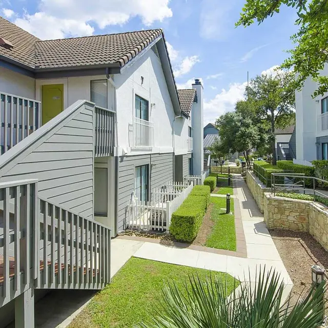 Exterior of Edge Studios rentals, with stairs to second-floor entry in San Antonio, TX