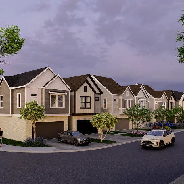 A view of a modern neighborhood with multiple houses lined up along a street. Each house features a mix of architectural styles with manicured lawns and trees. A few cars are parked along the road and a person is walking on the sidewalk.