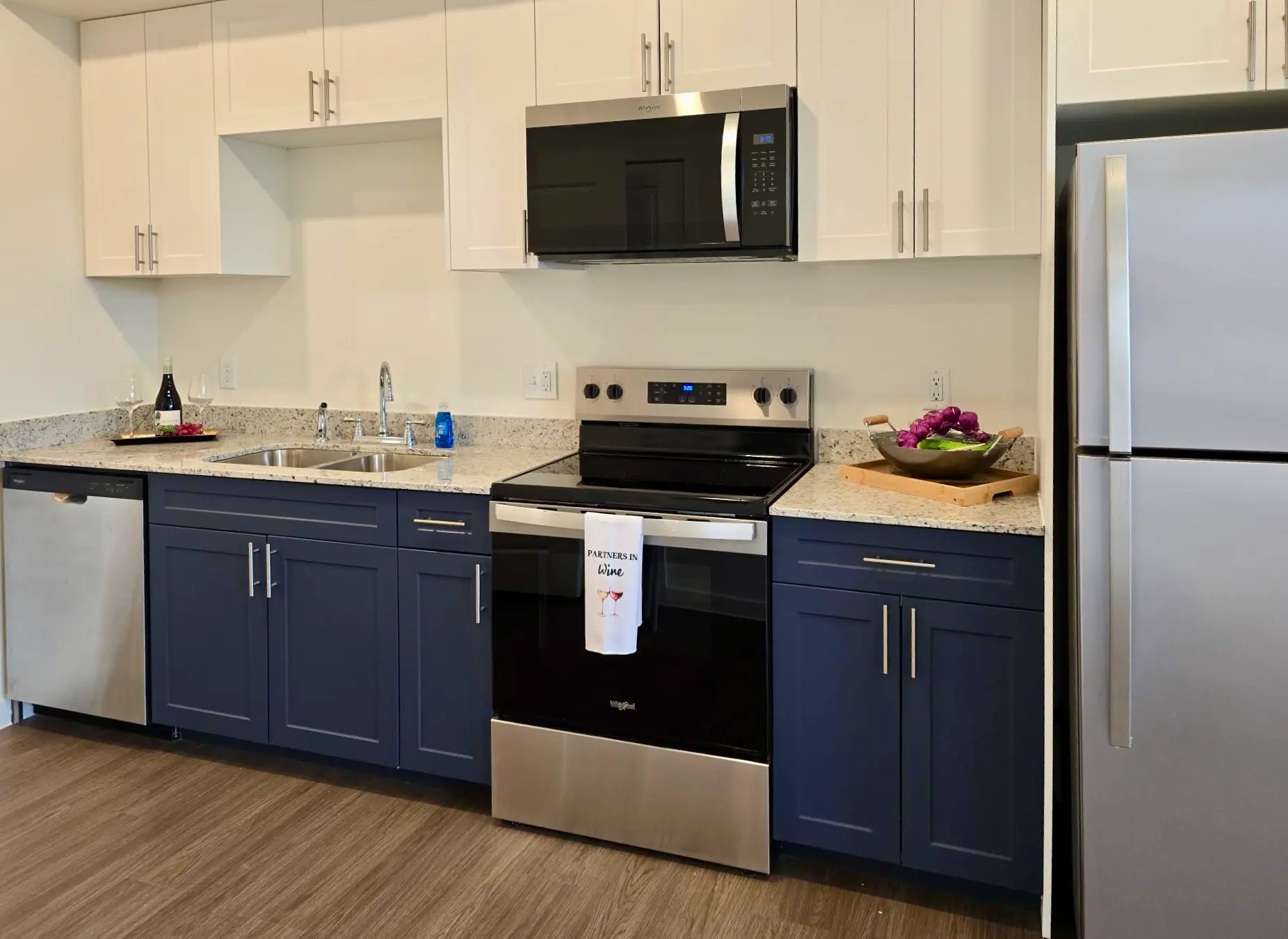 Modern Kitchen Interior A sleek, modern kitchen featuring a two-tone cabinetry, stainless steel appliances, and a stone countertop.