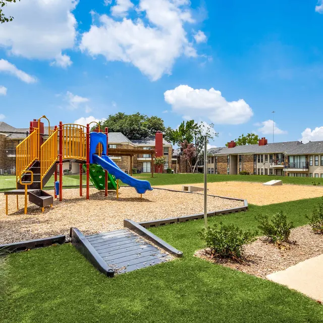 Playground with slide and corn hole at North Star Apartments