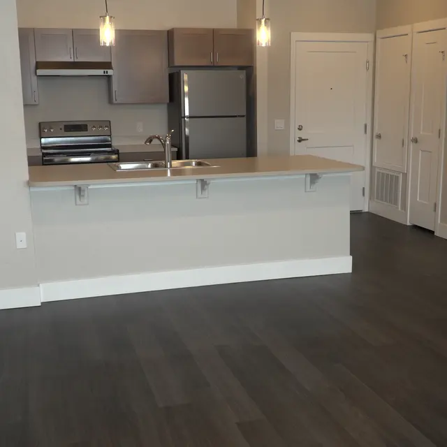 Interior view of a modern apartment with an open kitchen and living area.