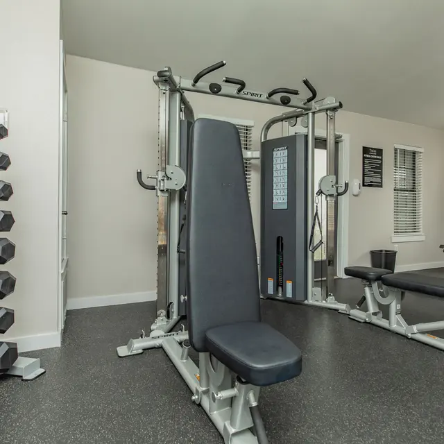 Artisan at South Lamar Free weights, bench press machine, and elliptical inside the fitness room at Artisan at South Lamar in Austin, TX