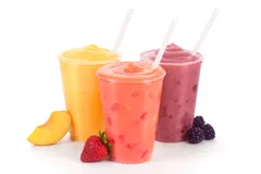 Three fruit smoothies with straws