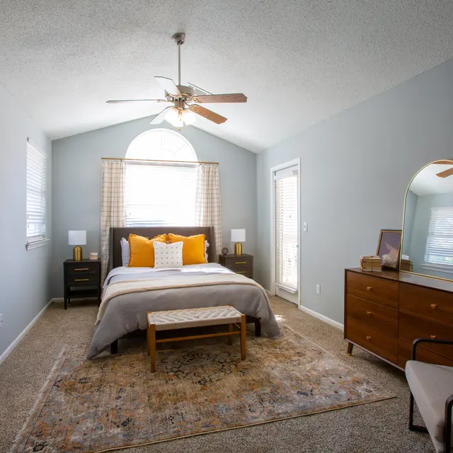Spacious apartment bedroom and bathroom with updated lighting and finishes at Centennial Crossing at Lenox Place