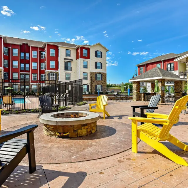 Columbia, MO Pet-Friendly Student Apartments - The Den - Fire Pit with Adirondack Chairs.