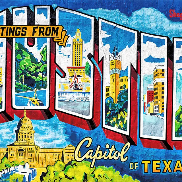 A vibrant mural depicting the phrase 'Greetings from Austin' with images of the Texas State Capitol and various landmarks in Austin, Texas.