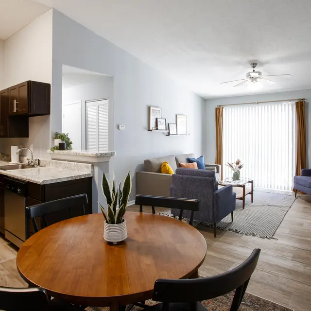 Renovated apartment living room, kitchen, and bedroom interiors with modern finishes at Centennial Crossing at Lenox Place