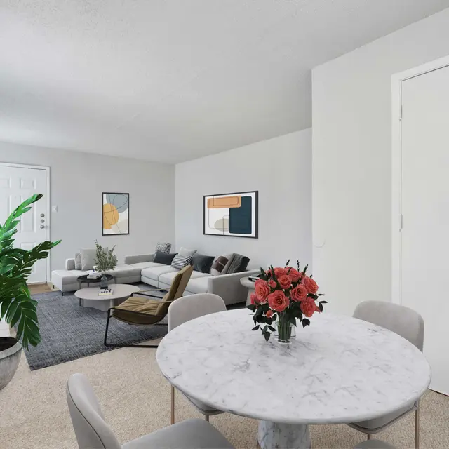 Furnished dining area with round table and four chairs, living area with sectional and coffee table and carpeted flooring, and lots of natural lighting at Dallas apartments