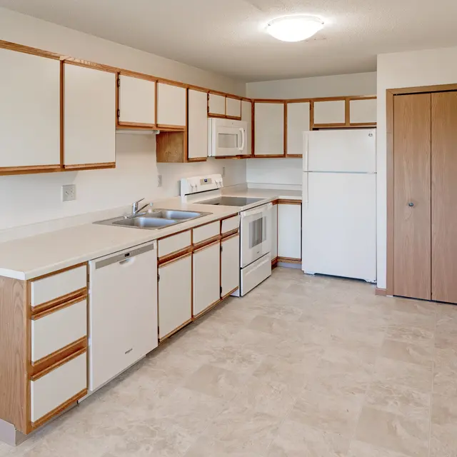 Court Place - Kitchen Renovated kitchen with light-colored cabinets and modern appliances.