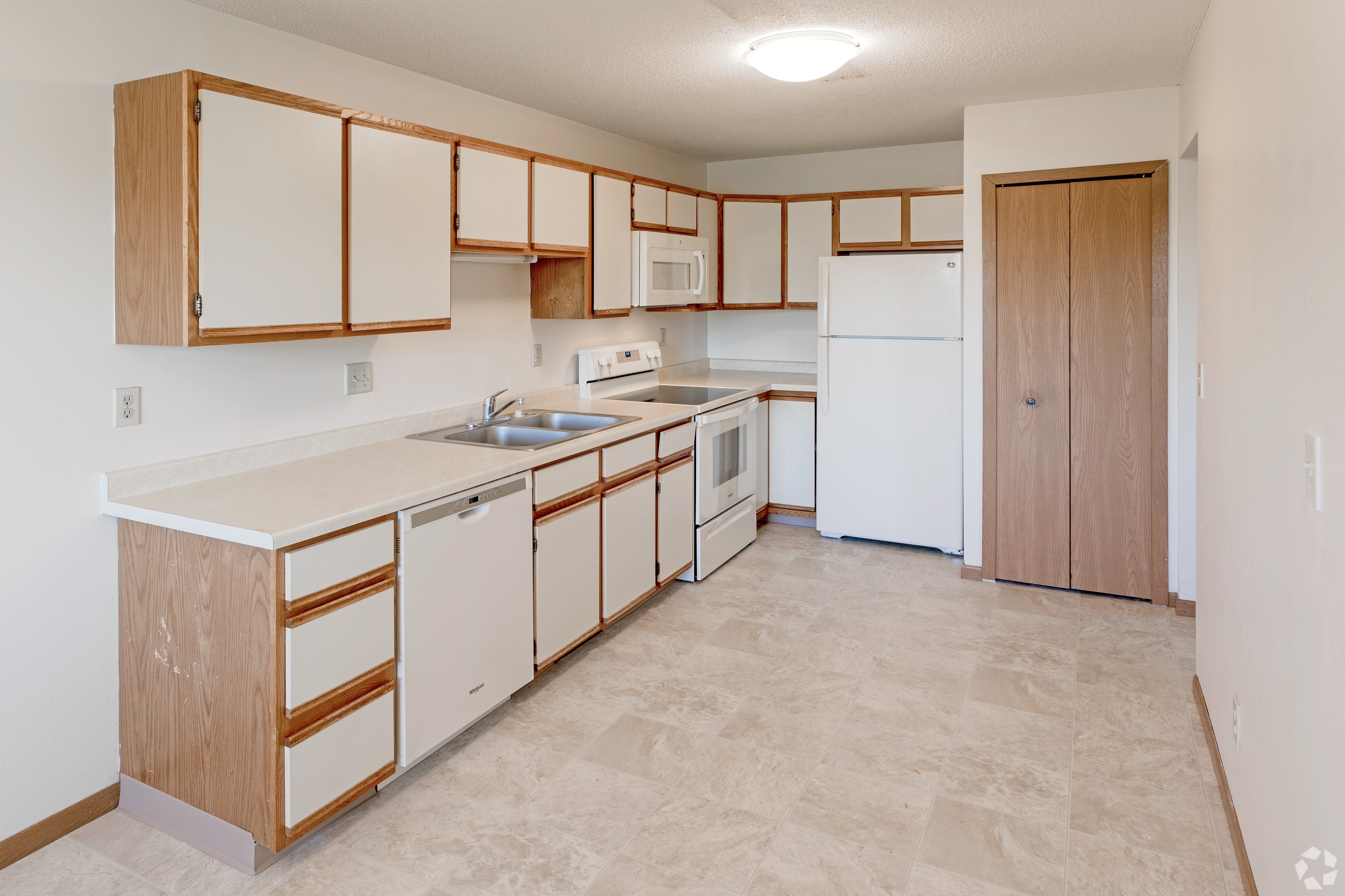 Court Place - Kitchen Renovated kitchen with light-colored cabinets and modern appliances.