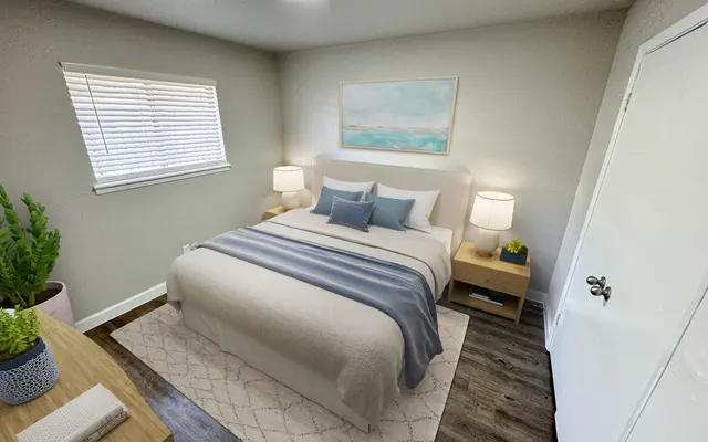 Cozy Modern Bedroom A modern bedroom featuring a large bed with a white and blue striped blanket, two bedside lamps on wooden nightstands, and a plant in the corner. The walls are a soft grey and there's a painting above the bed. The window has horizontal blinds and the floor has a decorative rug beneath the bed.