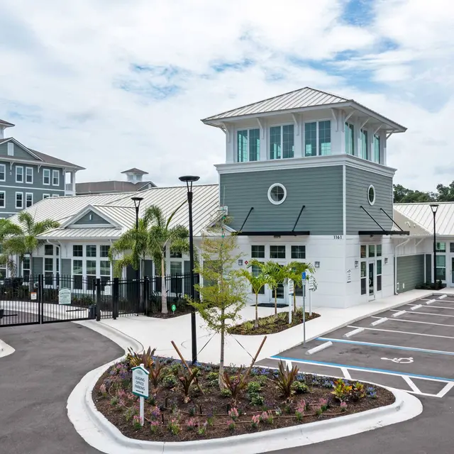 ShoreView Exterior of ShoreView Waterfront's leasing office with accessible parking and a secure gated entrance leading to the community.