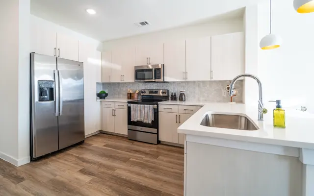 Modern Kitchen Interior Contemporary kitchen with stainless steel appliances, light wood cabinets, and a clean layout featuring a sink and countertop.
