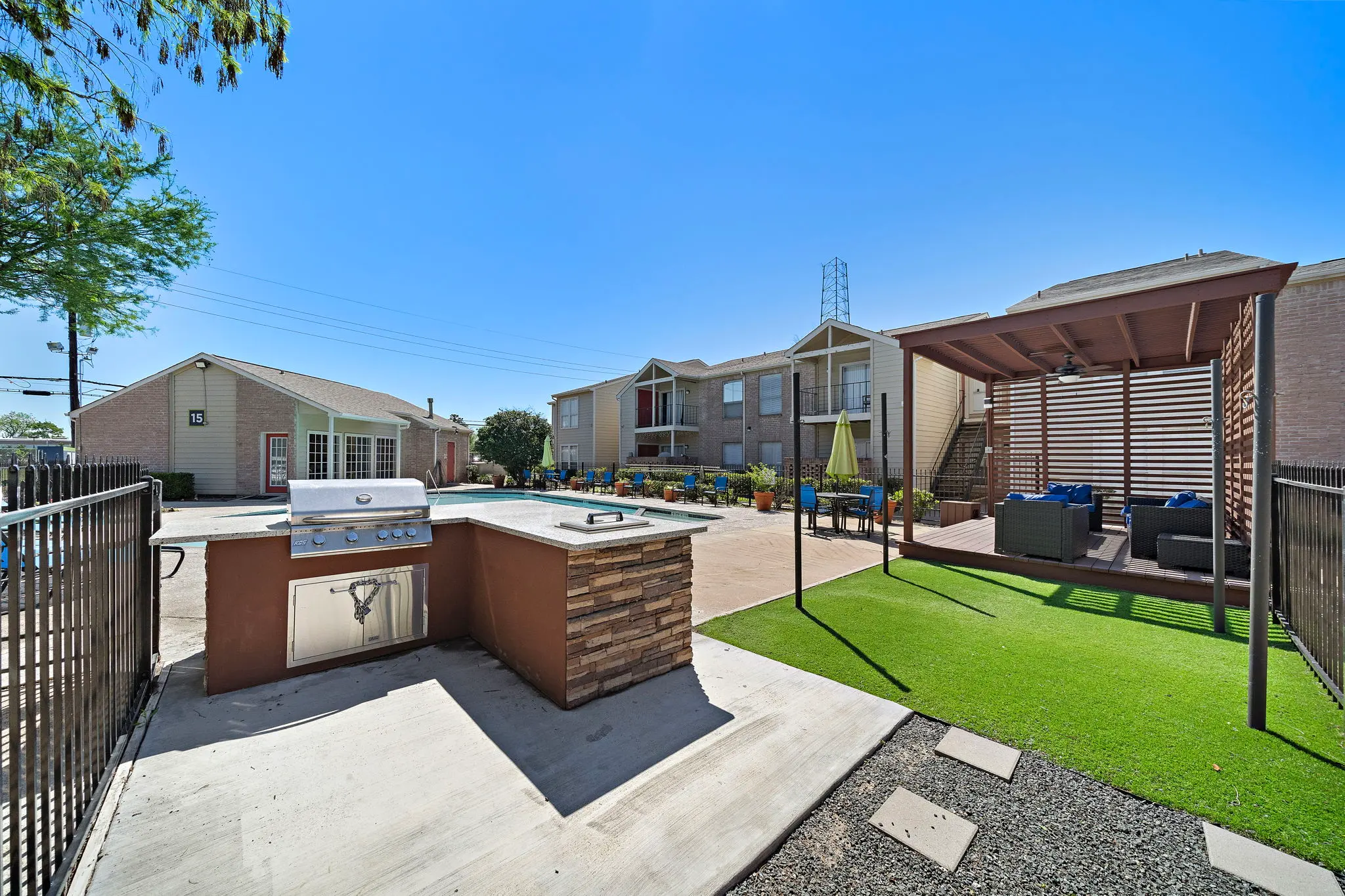Outdoor Grilling and Relaxation Area A sunny outdoor space featuring a grilling station and a cozy seating area.