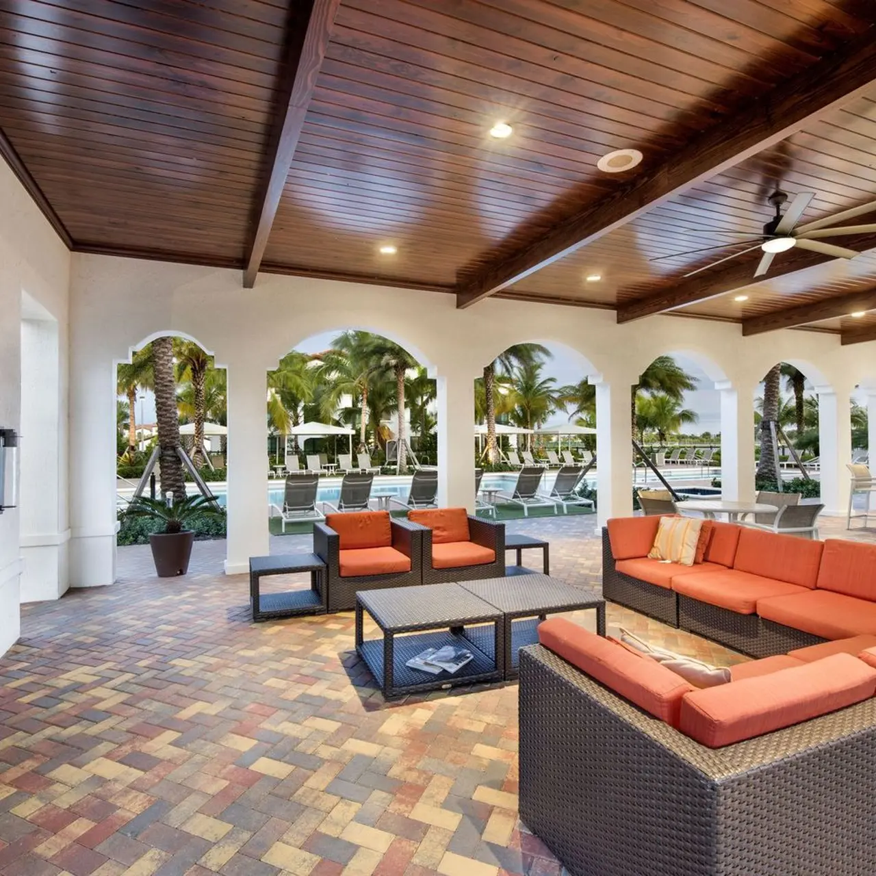 cabana lounge area with television and outdoor couch