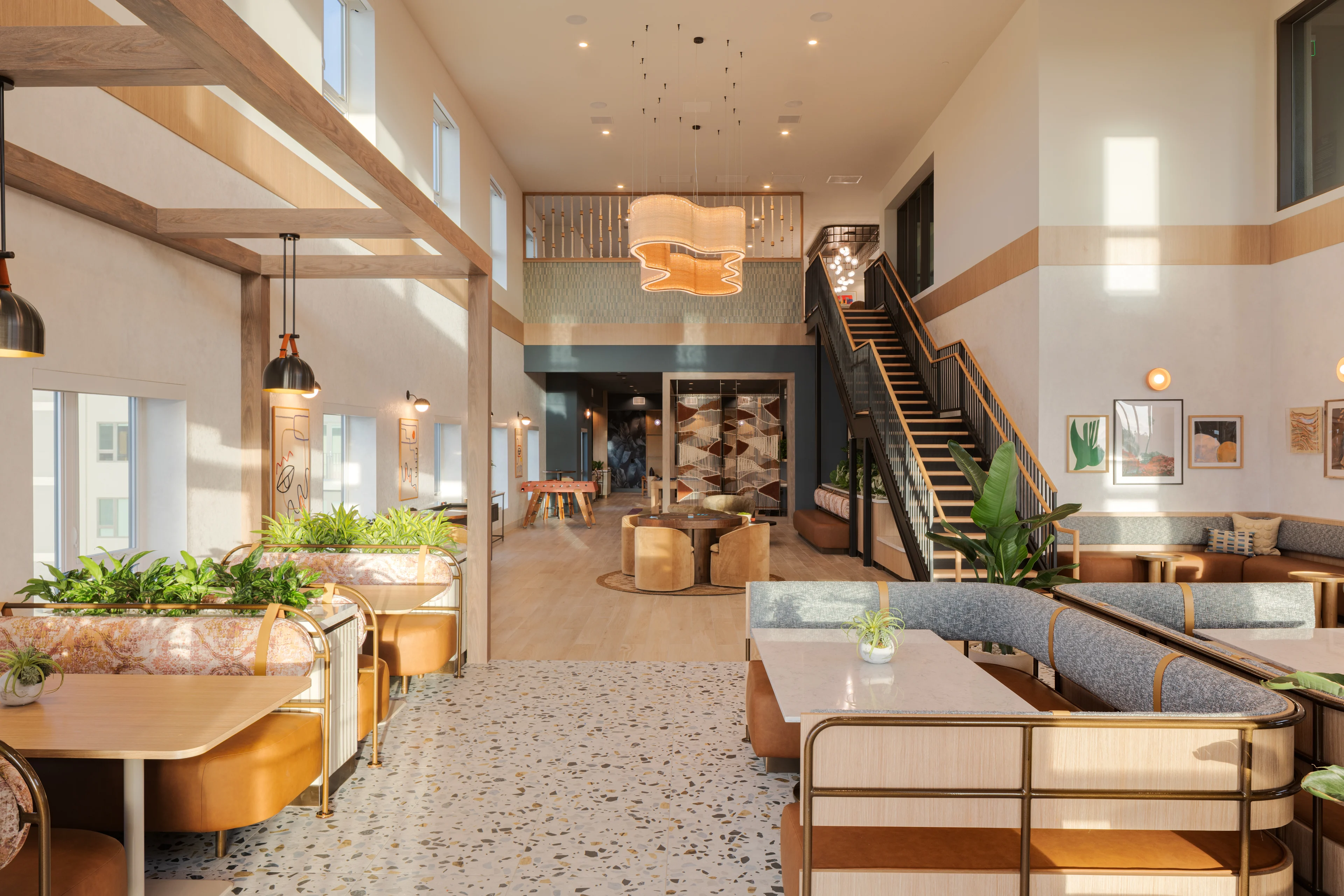 A modern interior design featuring a spacious lounge area with natural light and plants.