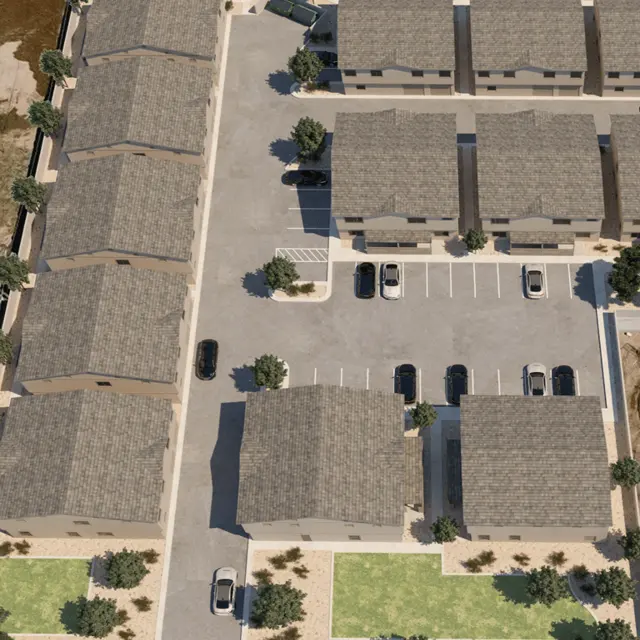 Aerial View of Residential Complex Aerial view of a residential complex with several buildings, parking lots, and landscaped areas.