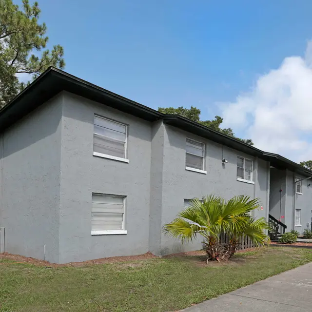 Alderman Park Apartments External view of the apartment building at Alderman Park with grass and walk ways leading to the steps.