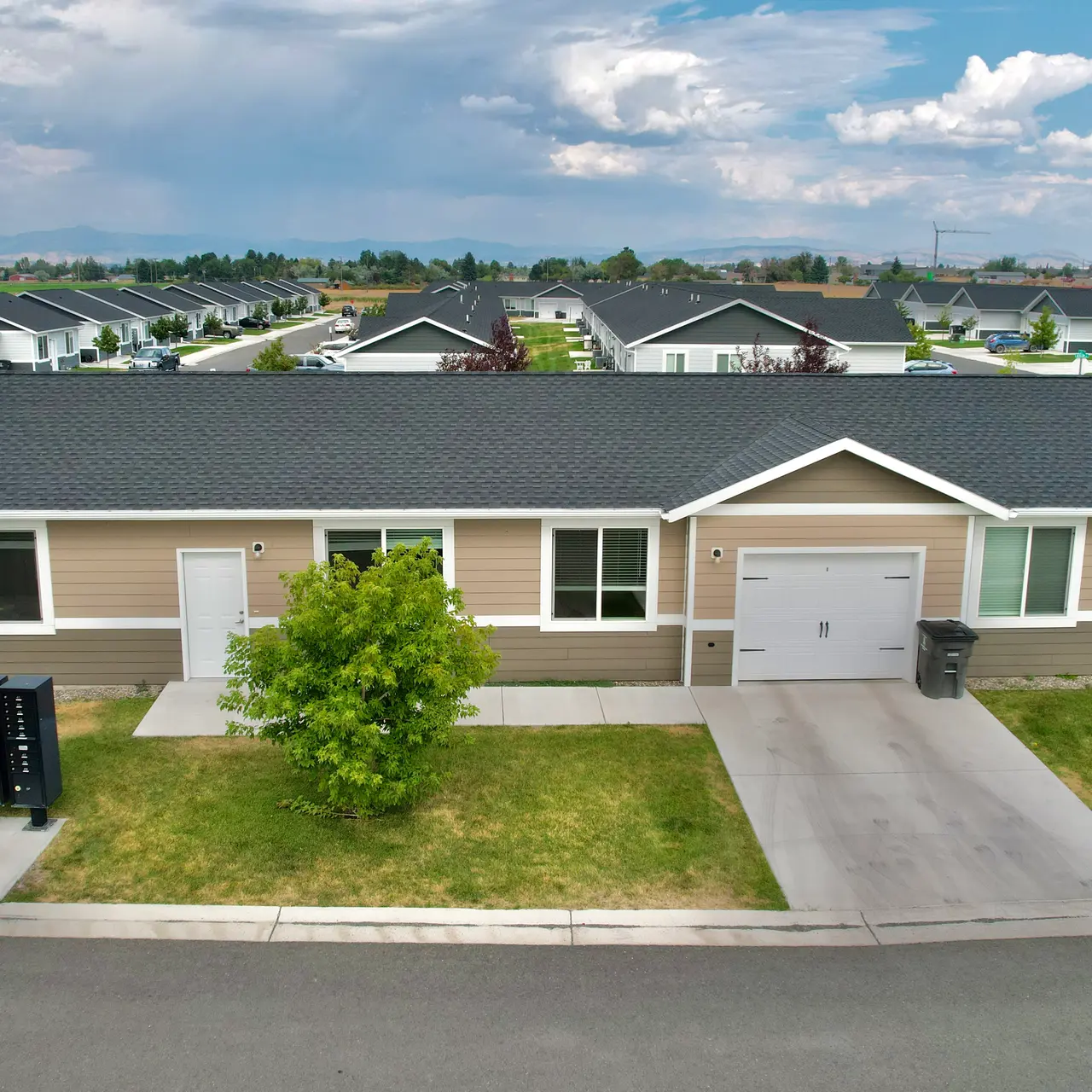 apartment aerial view Aerial view of Elkhorn Flats apartment complex in Helena, MT, showcasing its layout and surrounding environment, including mountains