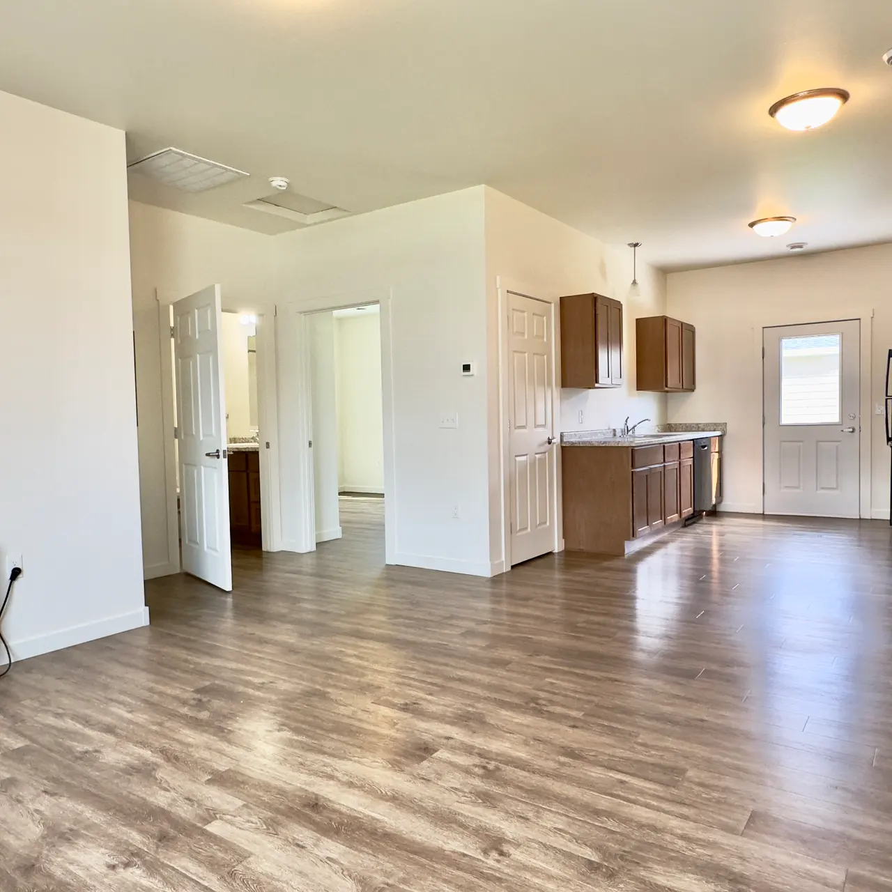 apartment living room An unfurnished apartment, showcasing empty rooms with bare floors and walls, providing a blank canvas for personalization and decor