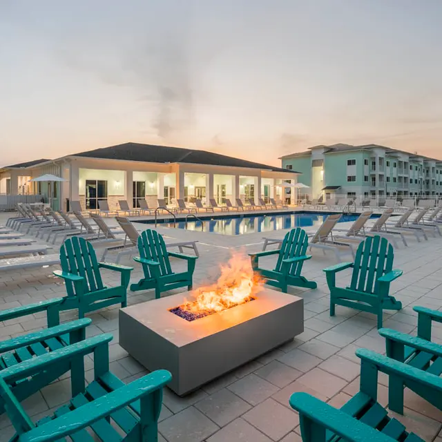 fire pit with lounge seats on the pool deck