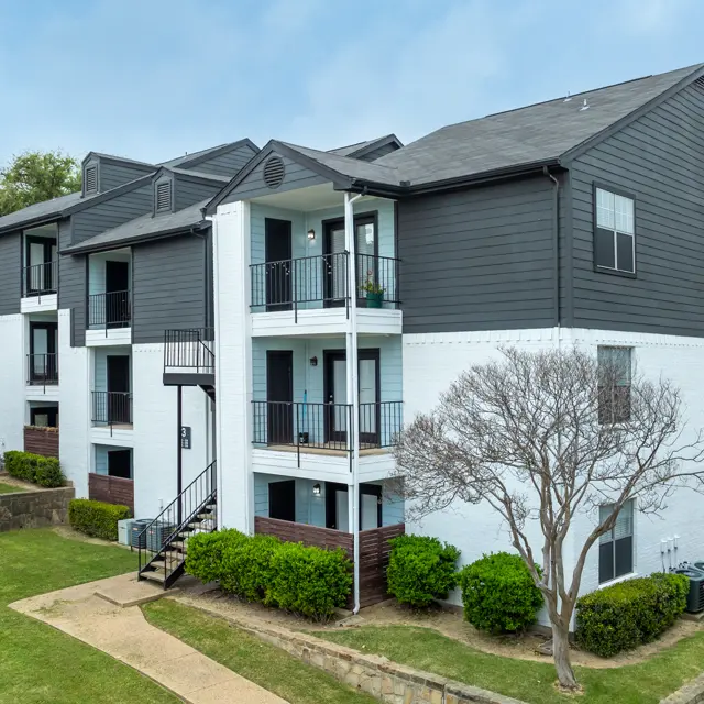 Exterior view of a modern apartment complex featuring two-toned color scheme and balconies