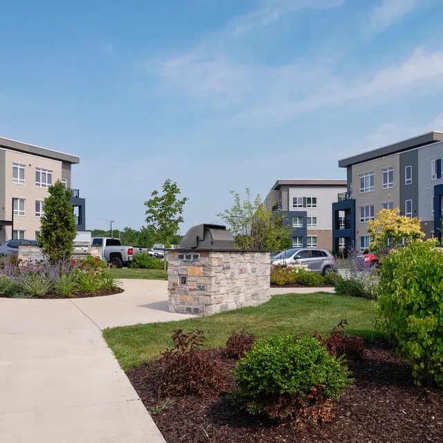 Hub13 View of a modern residential complex with landscaped gardens and pathways.