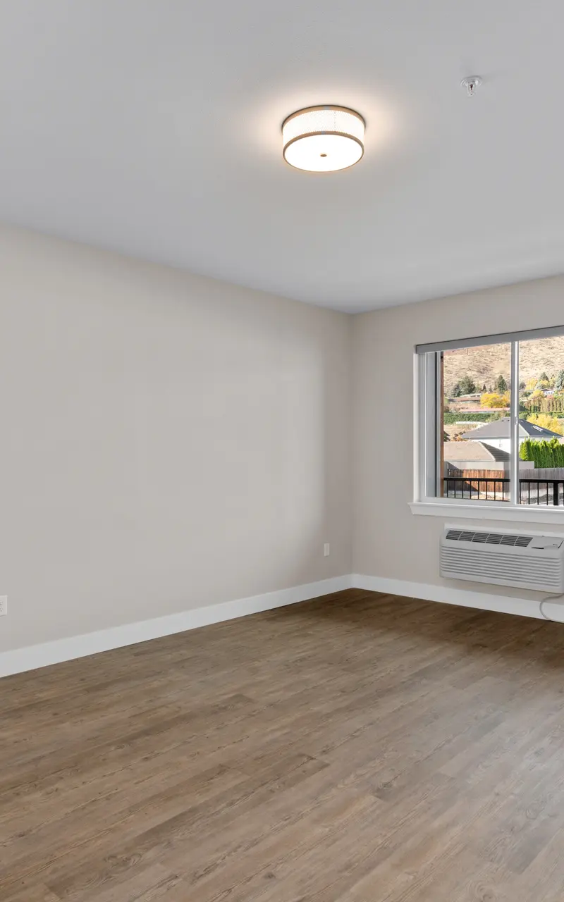 An unfurnished apartment, showcasing empty rooms with bare floors and walls, providing a blank canvas for personalization and decor