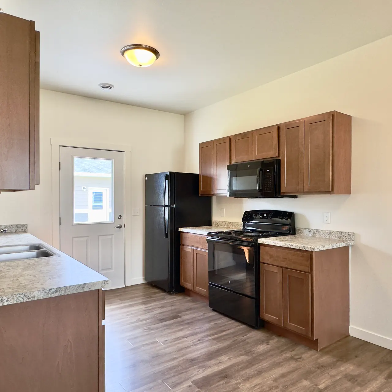 apartment kitchen Kitchen in a modern apartment, featuring sleek countertops, black appliances, and ample cabinet space