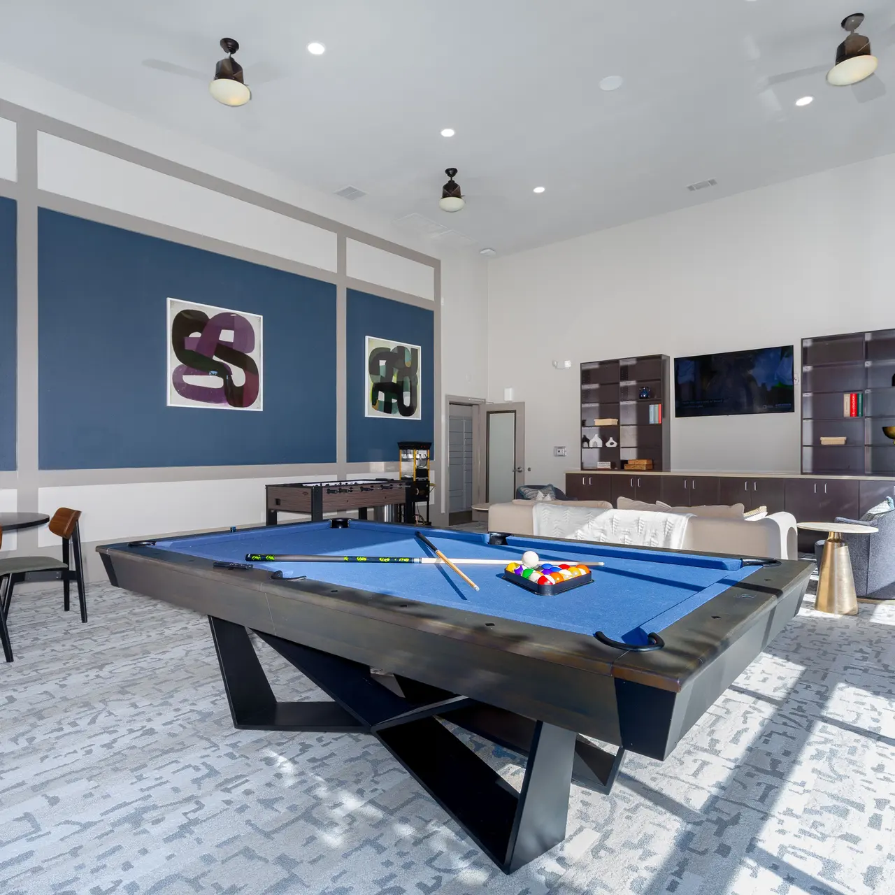 Resident Lounge A spacious game room featuring a pool table, comfortable seating, and modern decor.