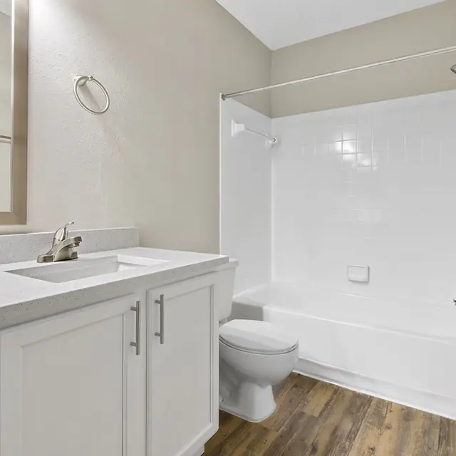 Bathroom with white furniture and white tile walls in the shower at Venice Park.