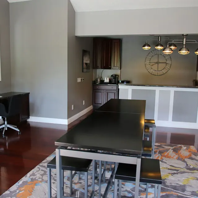 Clubhouse at Bradenton Reserve apartments in West Bradenton, FL with workstations, kitchen, and table seating.