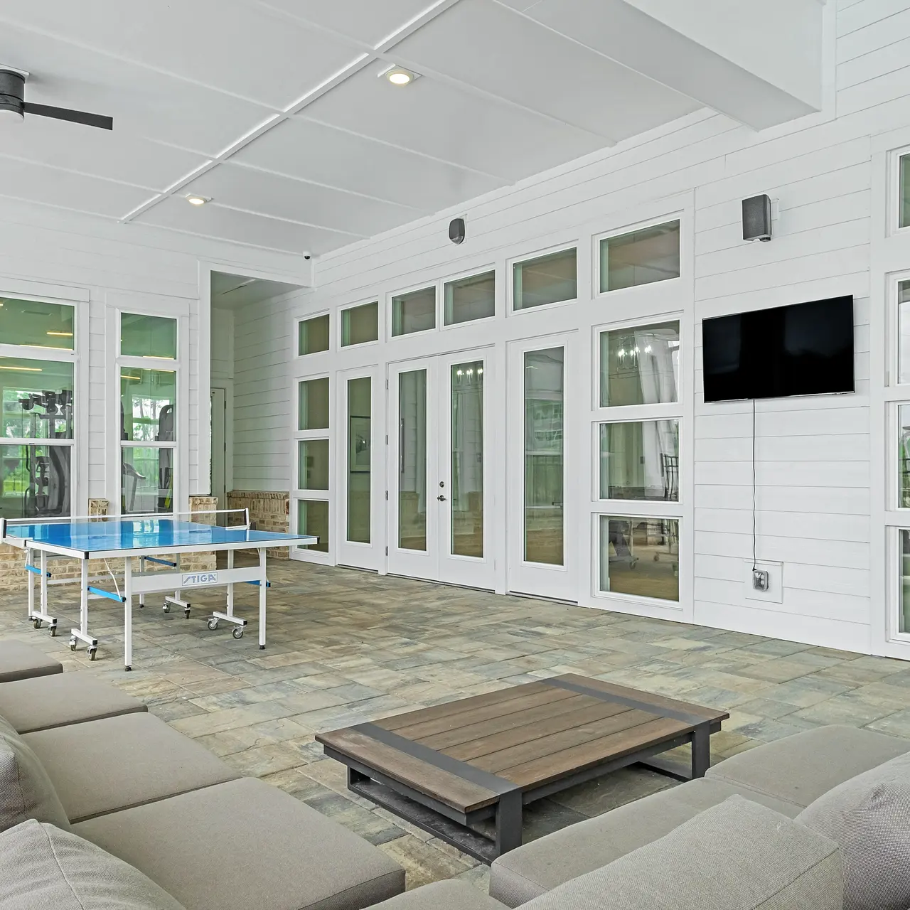 club house area with seating, a T.V. and a ping pong table