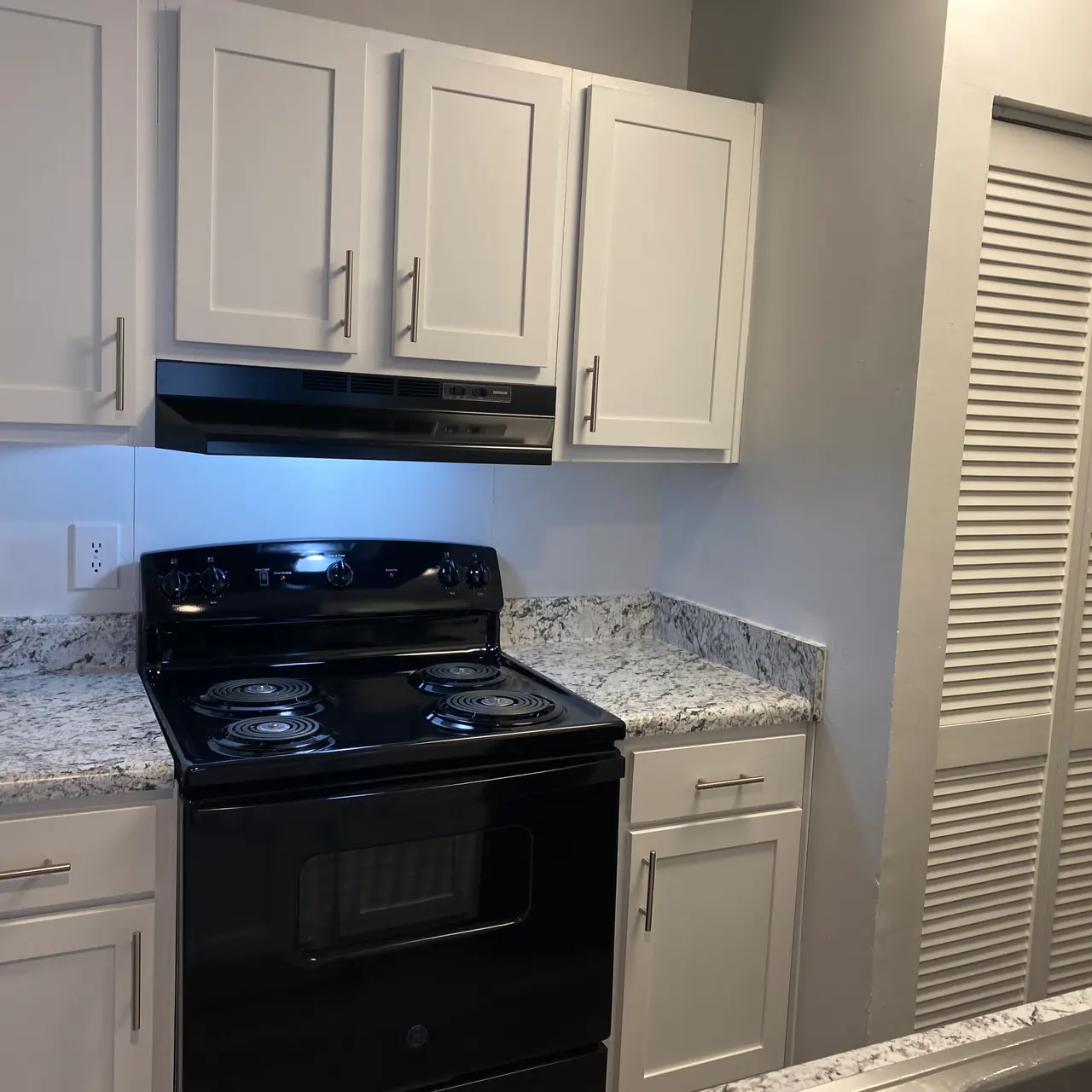 kitchen with crafted cabinets above the stove