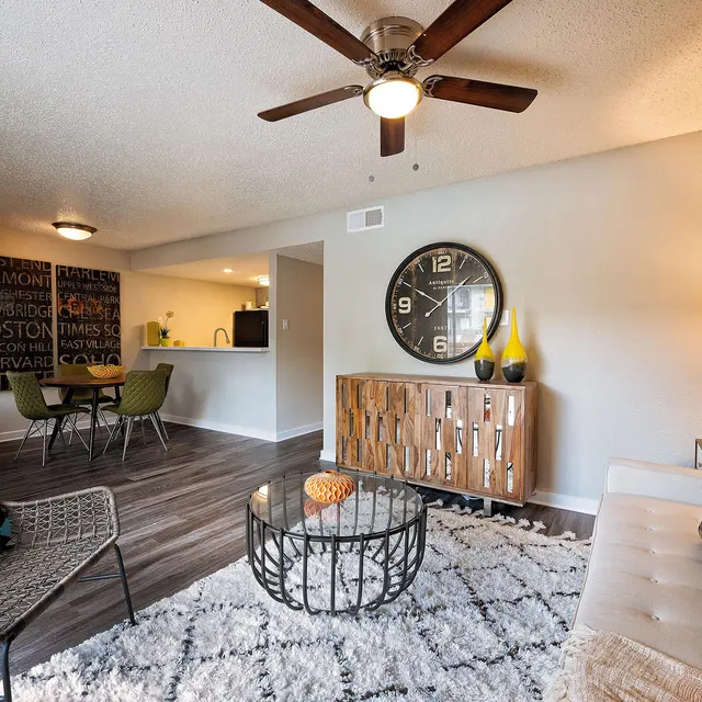 Artisan at South Lamar Furnished living room with couch, area rug, ceiling fan, and hardwood-style flooring