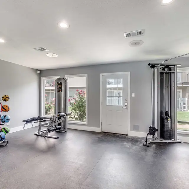 Fitness center with exercise balls, weights, medicine balls, and yoga equipment at North Star Apartments