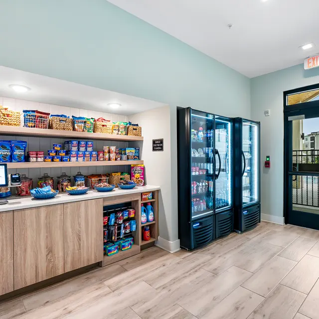 Hotel Convenience Store Interior Interior view of a hotel convenience store area with shelves stocked with snacks and a refrigerator display case.