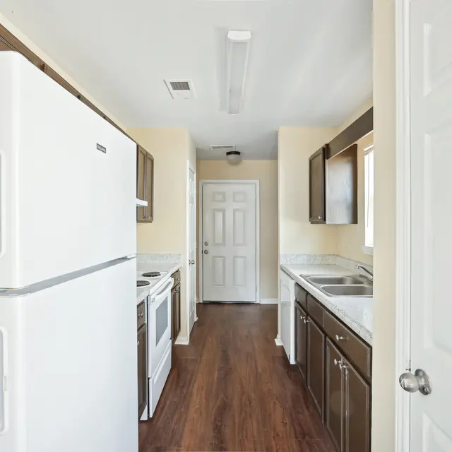 Modern Kitchen Interior Interior view of a modern kitchen with white appliances and wooden cabinets