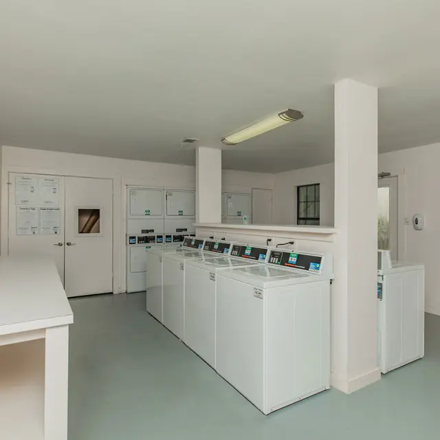 Artisan at South Lamar Laundry room with multiple machines, folding table and space for the community to use.