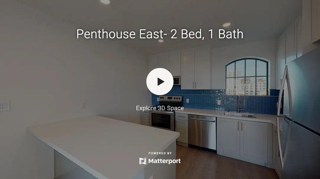 Modern kitchen in a penthouse with a white countertop and stainless steel appliances