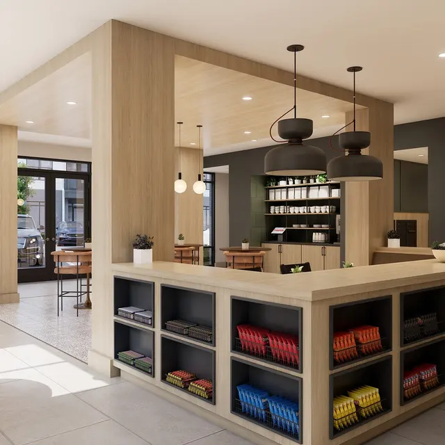 Interior of a modern coffee shop featuring a central counter with shelves displaying various items, and seating areas with tables and chairs.